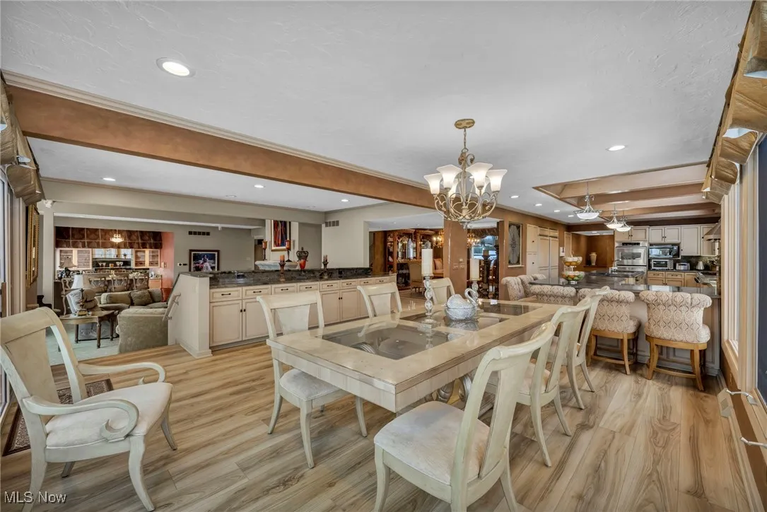 Breakfast Room open to Kitchen and Great Room, with a wall of windows overlooking your back yard with panoramic views of the river and your wooded ravined lot!