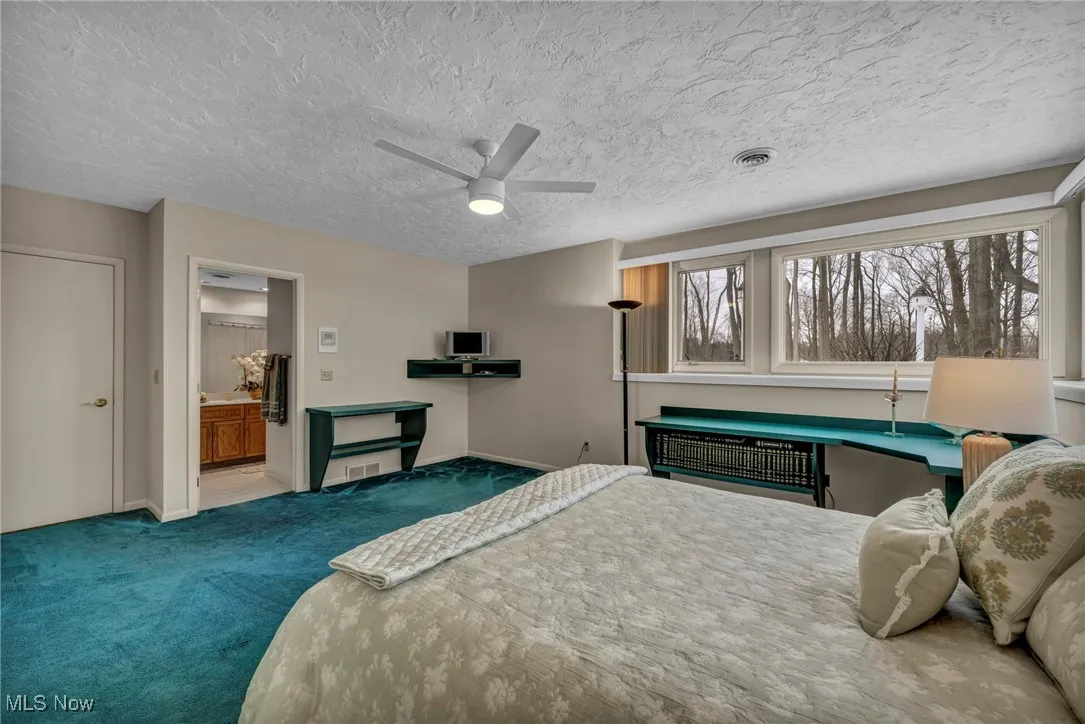 Large en-suite lower level bedroom has large built in study area.