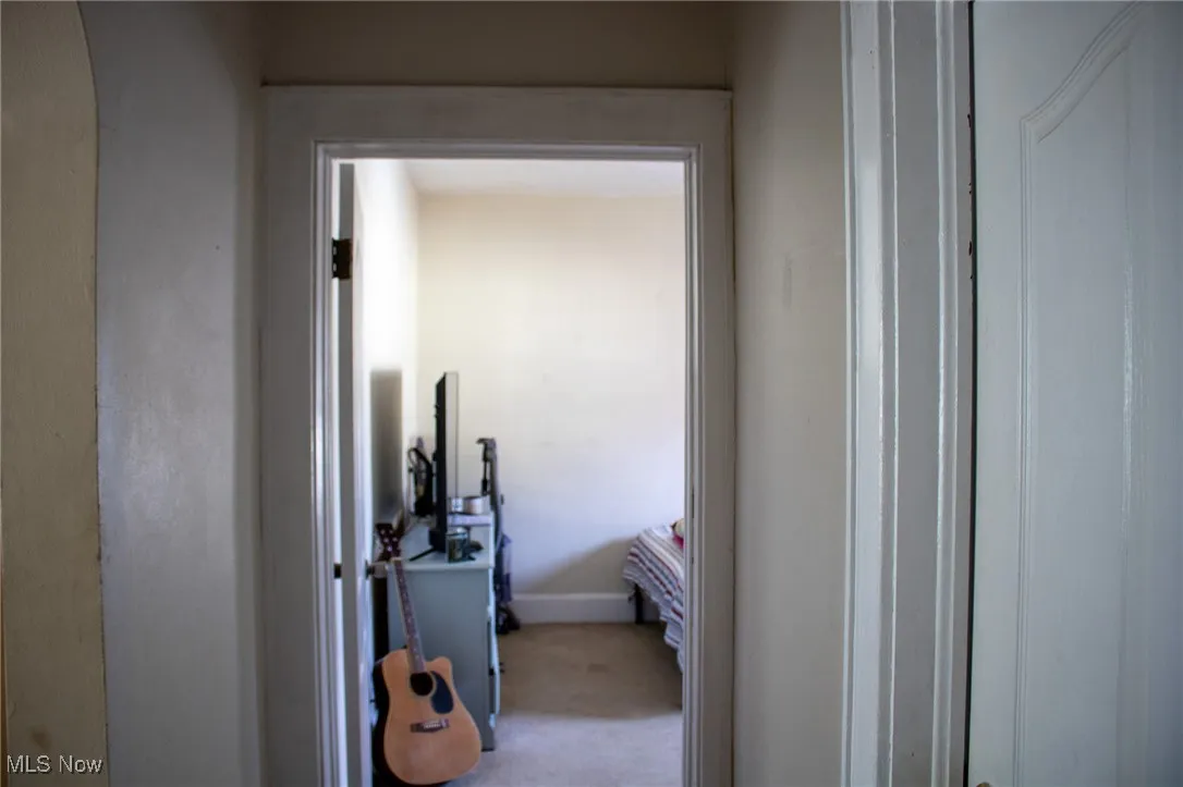 Corridor with carpet flooring and baseboards