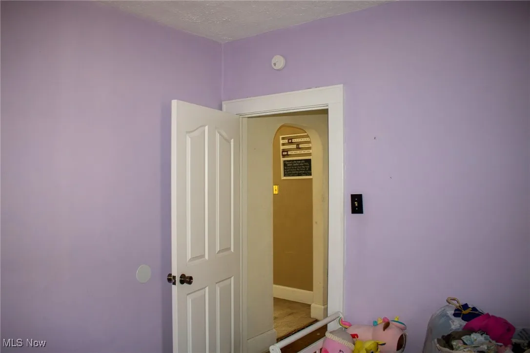 Playroom featuring a textured ceiling and carpet flooring