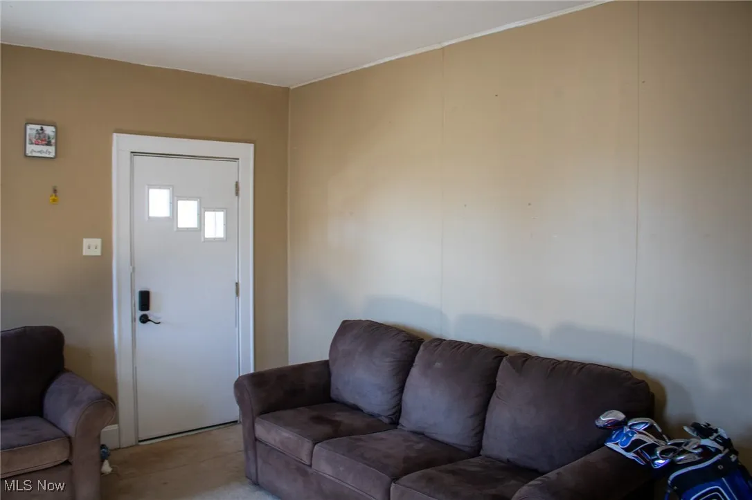 Living area featuring light colored carpet