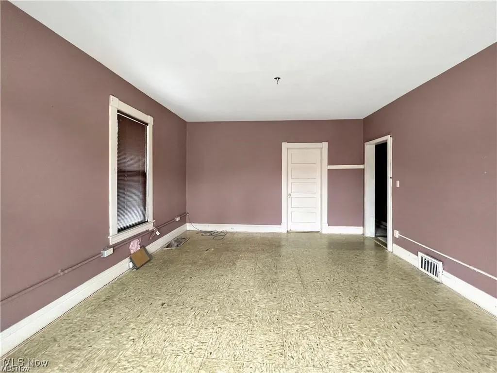 Spare room featuring visible vents and baseboards