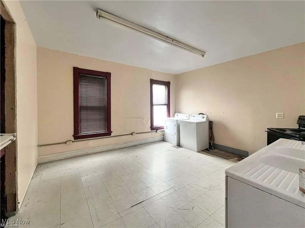 Washroom with laundry area, baseboards, and separate washer and dryer