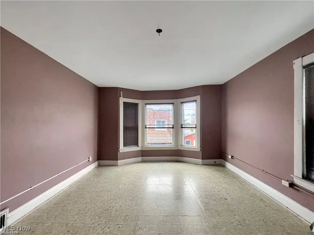 Unfurnished room with visible vents, baseboards, and tile patterned floors