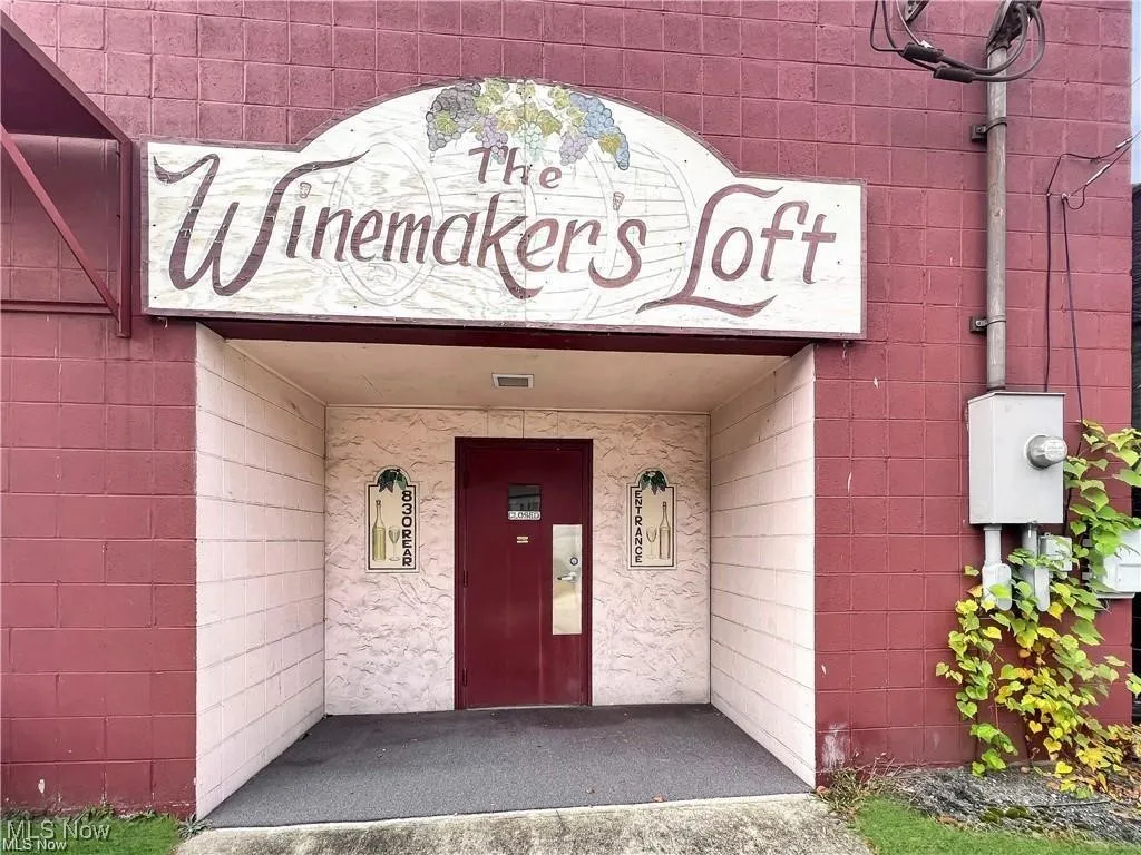 View of exterior entry with concrete block siding and elevator