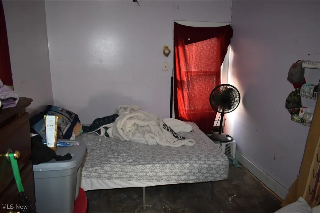 Bedroom with baseboards and wood finished floors