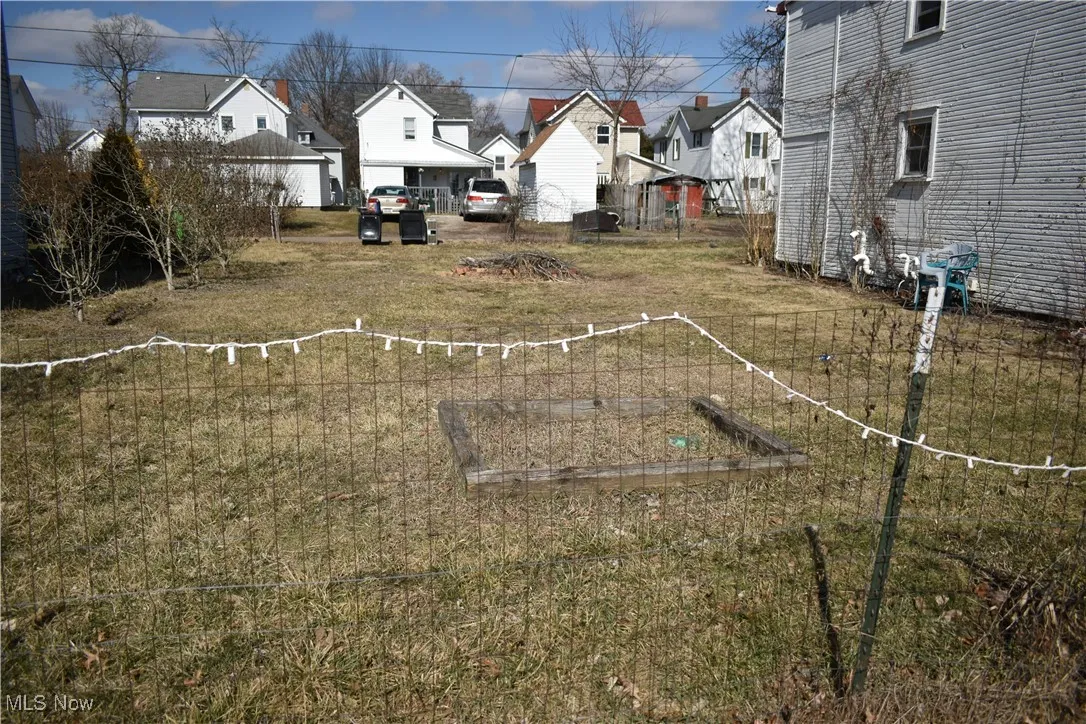 View of yard featuring a residential view and a garden