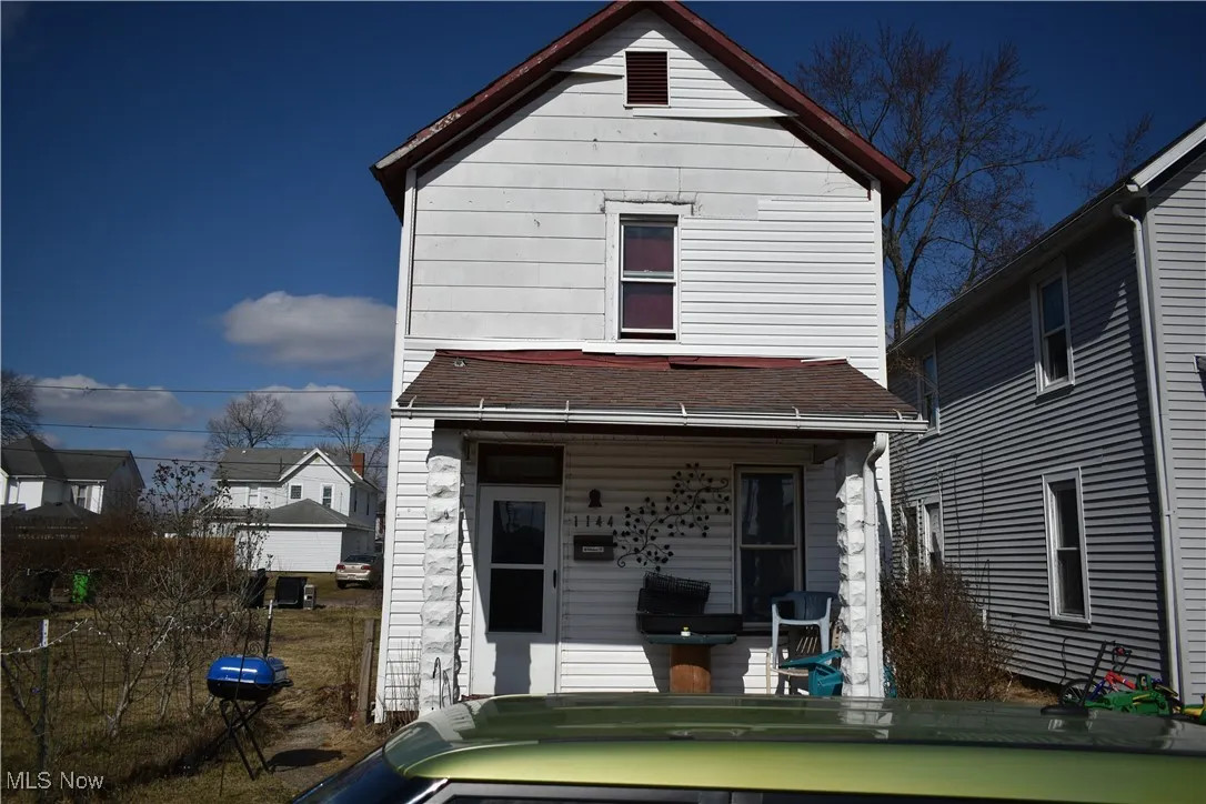 View of front of house with a porch and roof with shingles