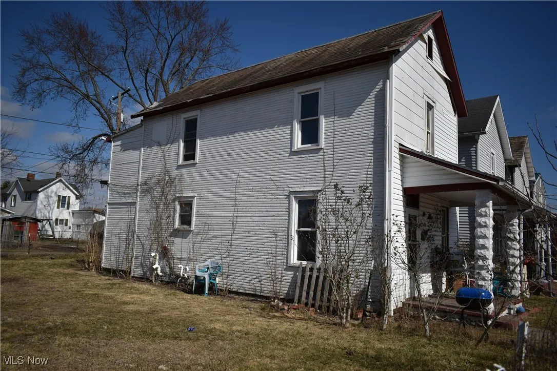 View of side of property with a yard