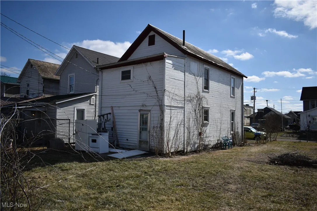 Back of property featuring a yard