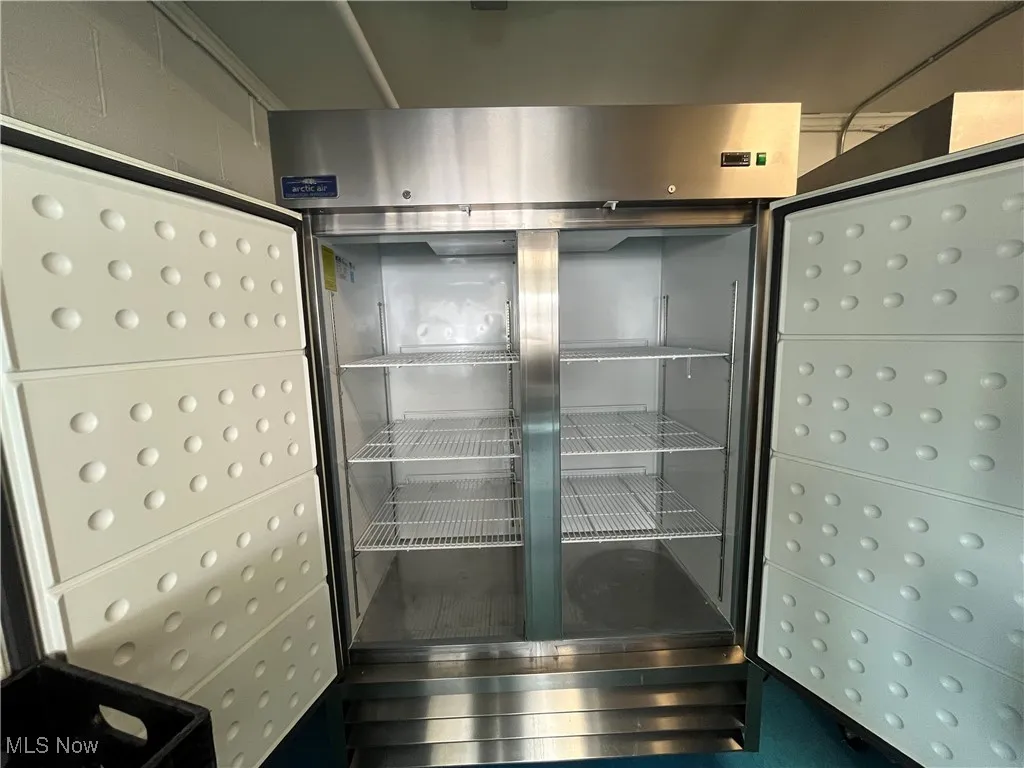 Interior details featuring refrigerator with glass door and mail area