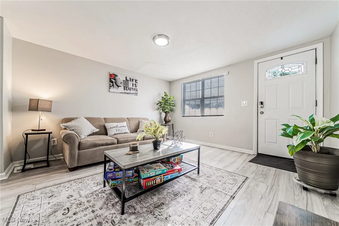 Living room featuring light wood-type flooring and baseboards