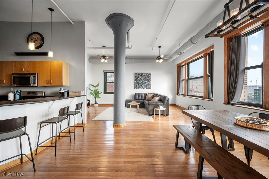 Dining room featuring light wood-style floors, ceiling fan, and baseboards