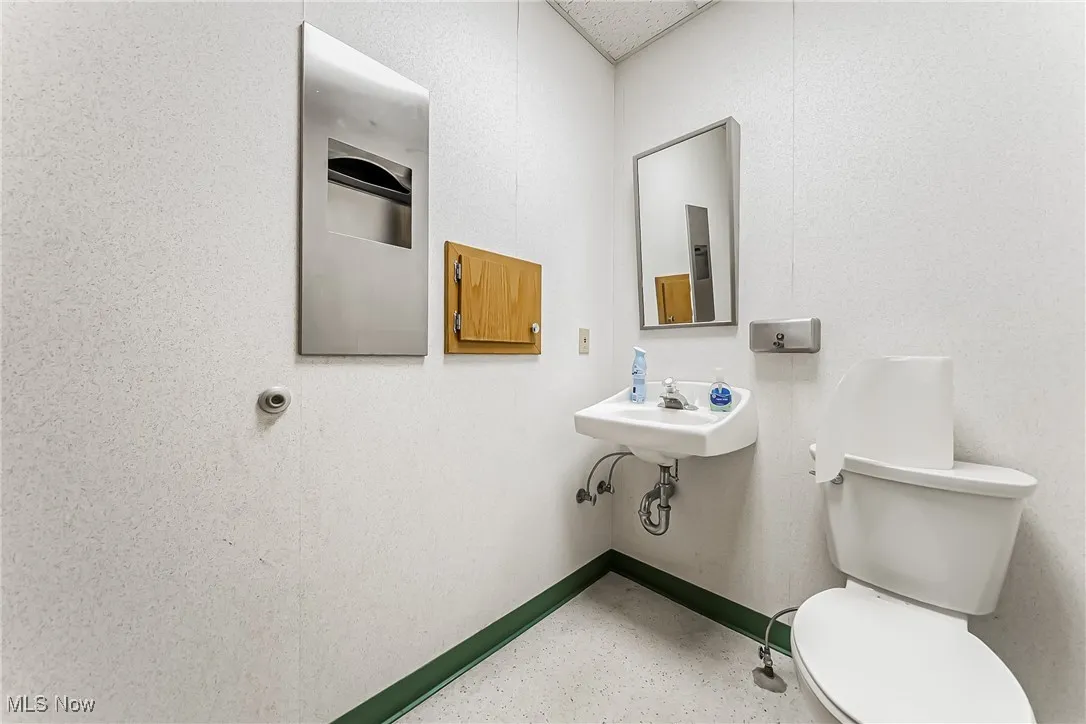 Bathroom with toilet and baseboards
