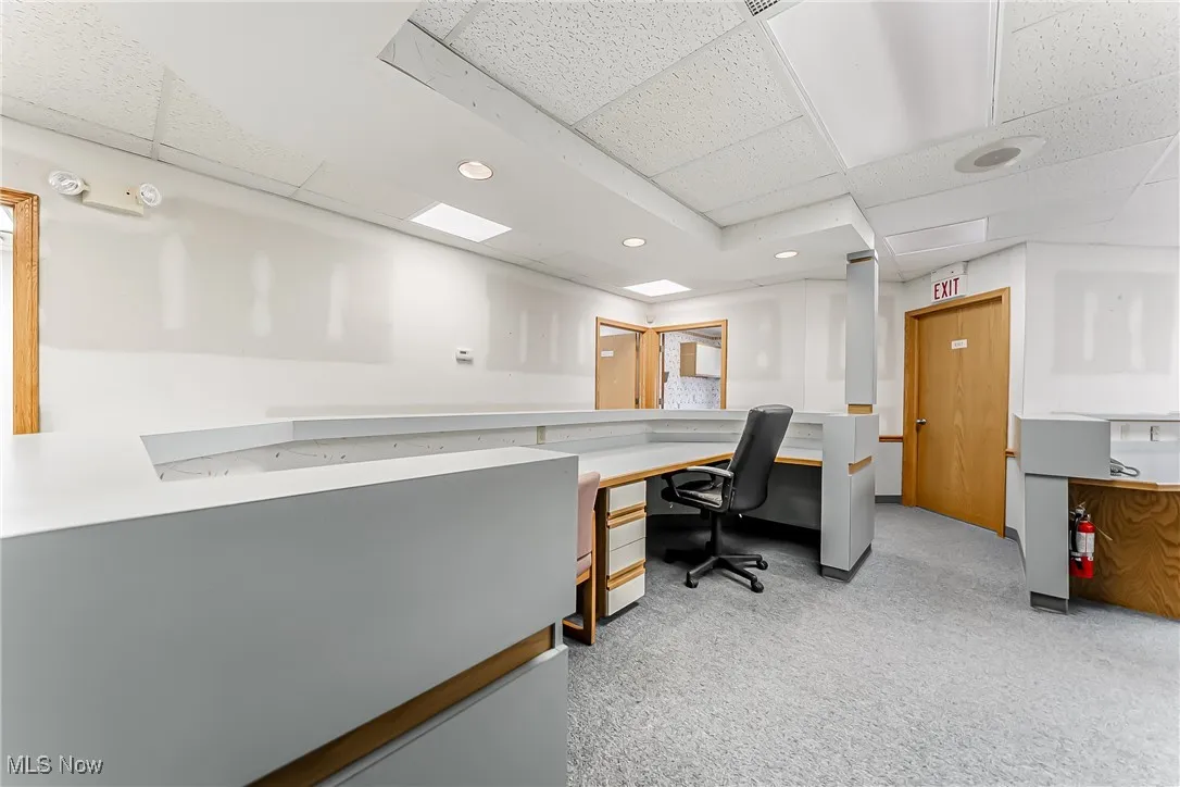 Office space featuring carpet floors, a paneled ceiling, and recessed lighting