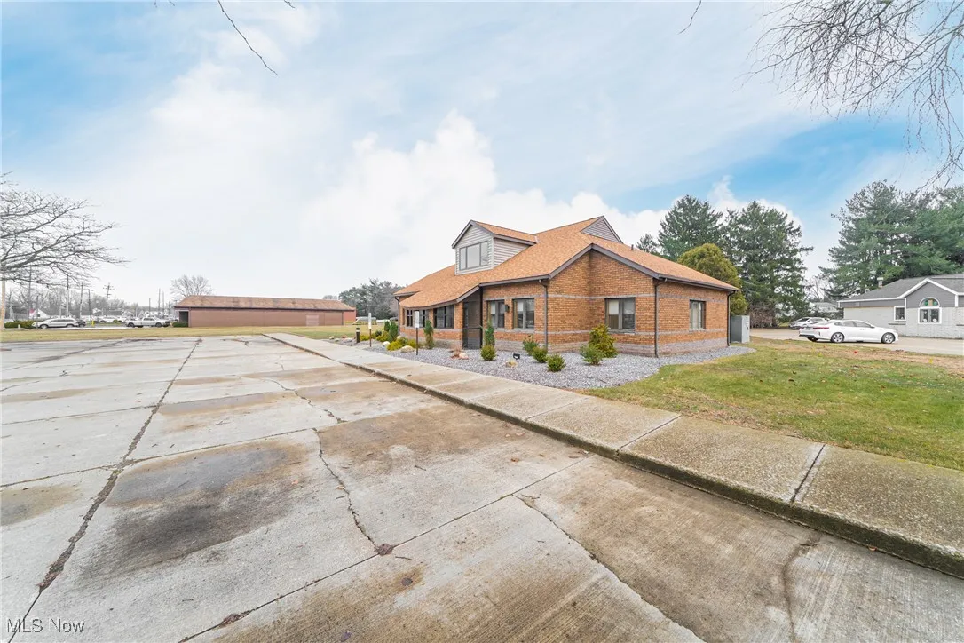 View of front of property with a front lawn and brick siding