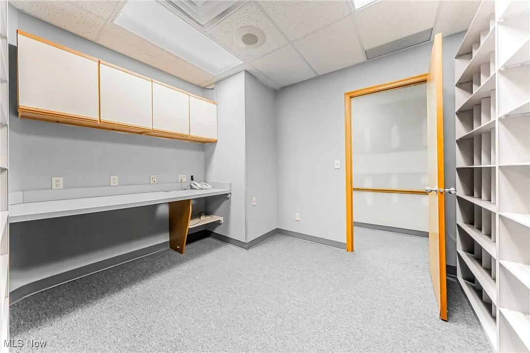 Office featuring baseboards and a drop ceiling