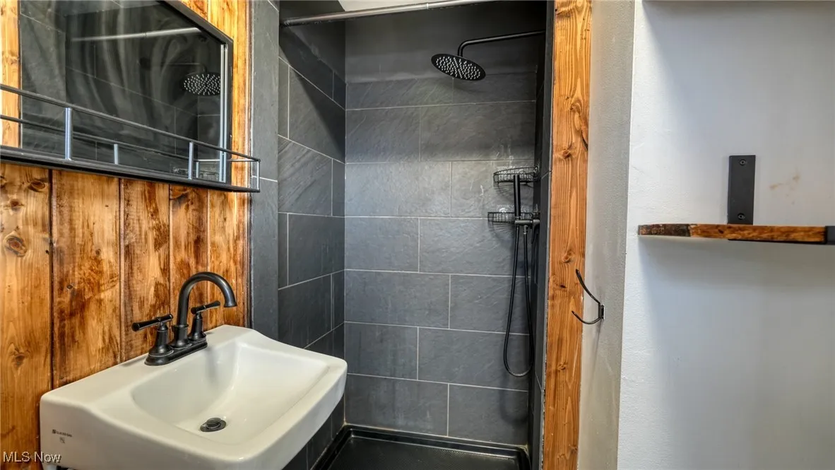 Bathroom with a sink and a tile shower