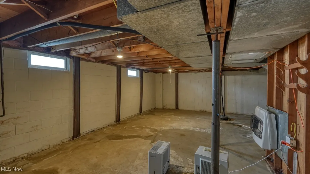 Below grade area with plenty of natural light and heating unit