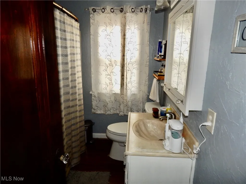 Upstairs unit Bathroom featuring bathtub/shower, toilet and vanity