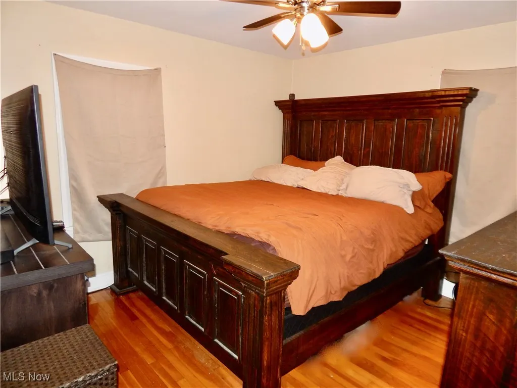 Bedroom with hardwood floors and a ceiling fan