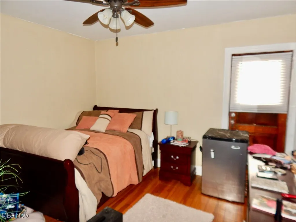 Bedroom with ceiling fan and hardwood floors