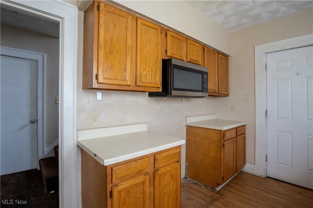 Kitchen with stainless steel microwave, sink, and cabinets