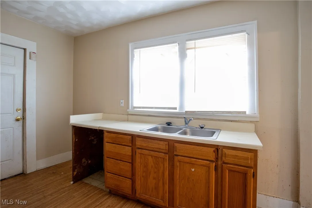 Kitchen with stainless steel microwave, sink, and cabinets