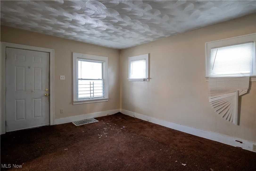 Carpeted entrance featuring baseboards