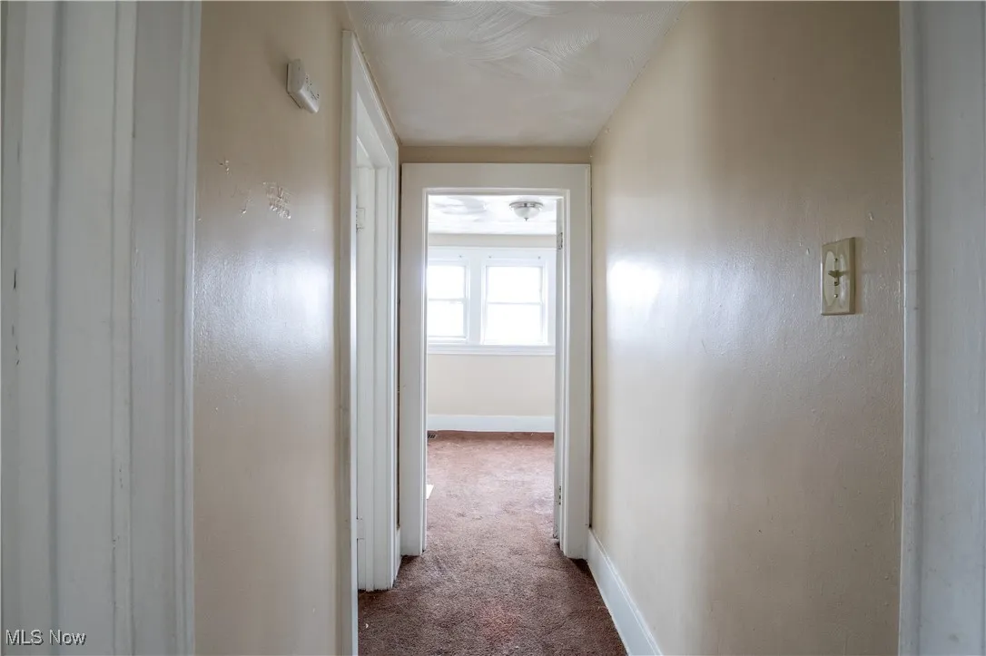Hallway featuring carpet flooring