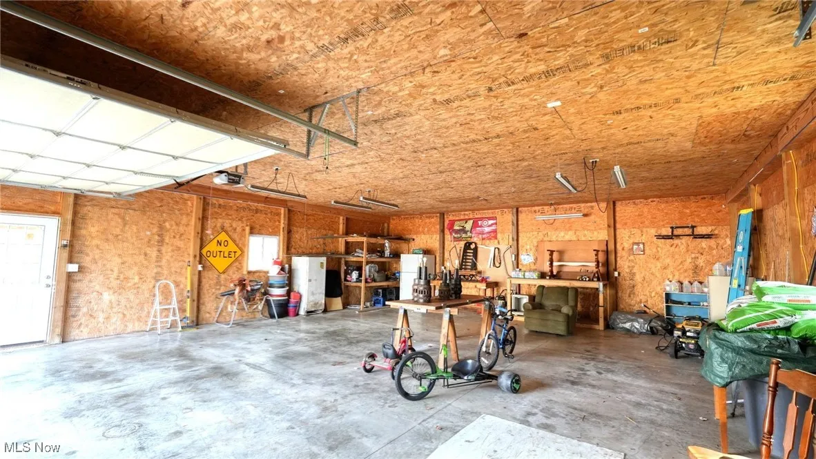 Garage with a workshop area and a garage door opener