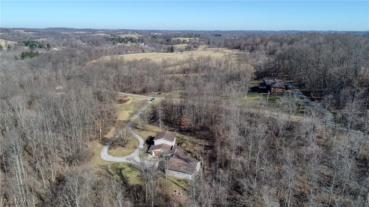 Birds eye view of property with a rural view and a view of trees