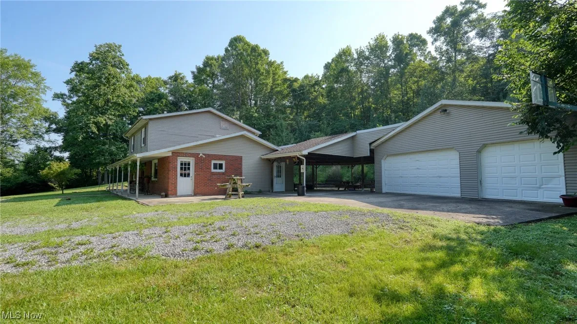 View of front facade with a front lawn, driveway, an attached garage, and brick siding