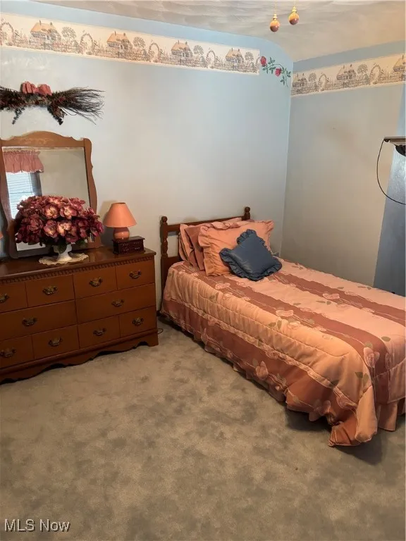 Bedroom featuring light colored carpet