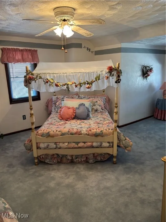 Bedroom with carpet flooring and a ceiling fan