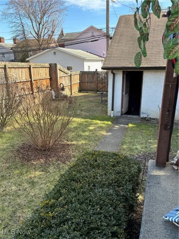 View of yard with a storage shed, an outdoor structure, and a fenced backyard