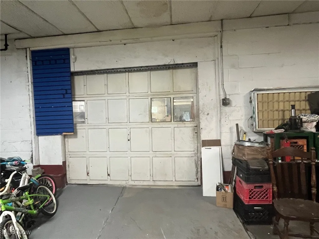 Garage featuring concrete block wall