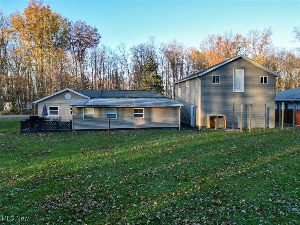Rear view of house featuring a yard