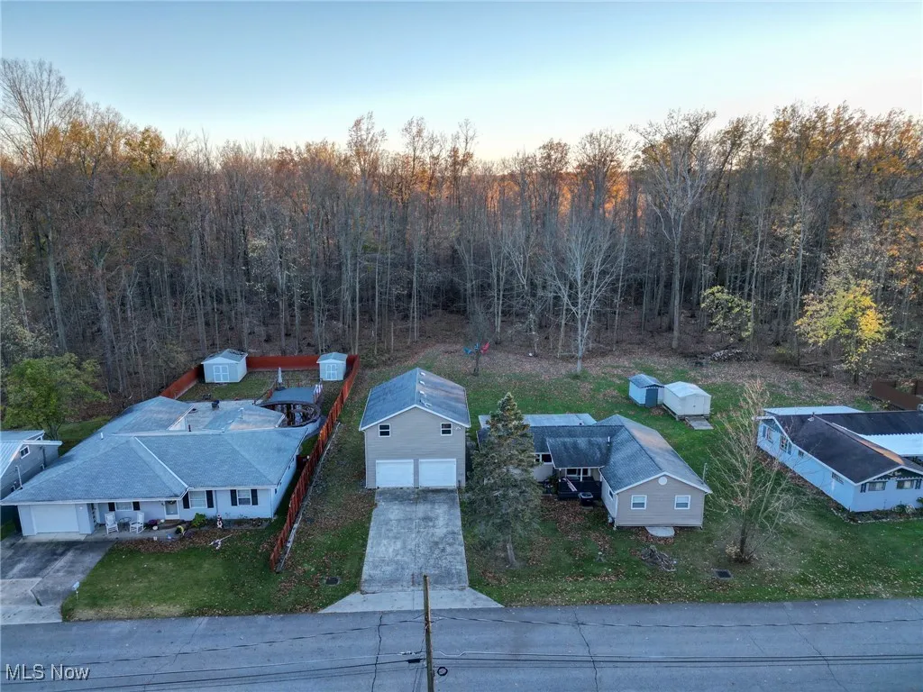 Birds eye view of property with a view of trees