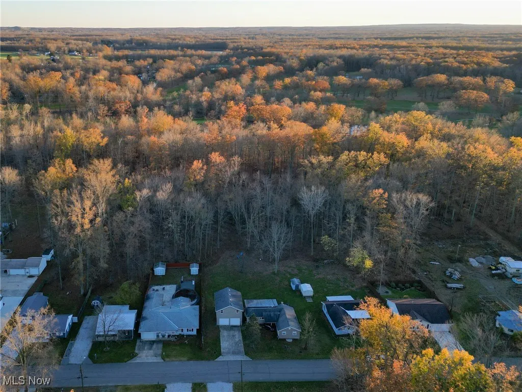 Aerial view featuring a wooded view