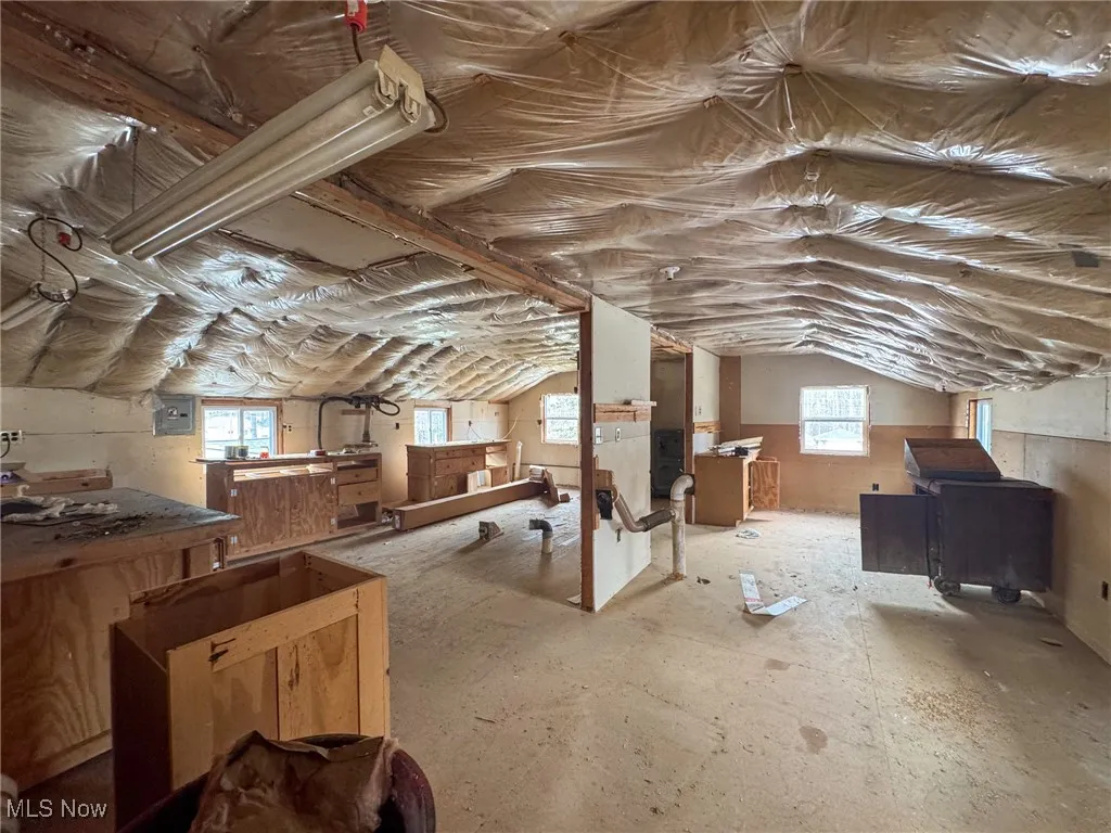 Unfinished attic featuring electric panel