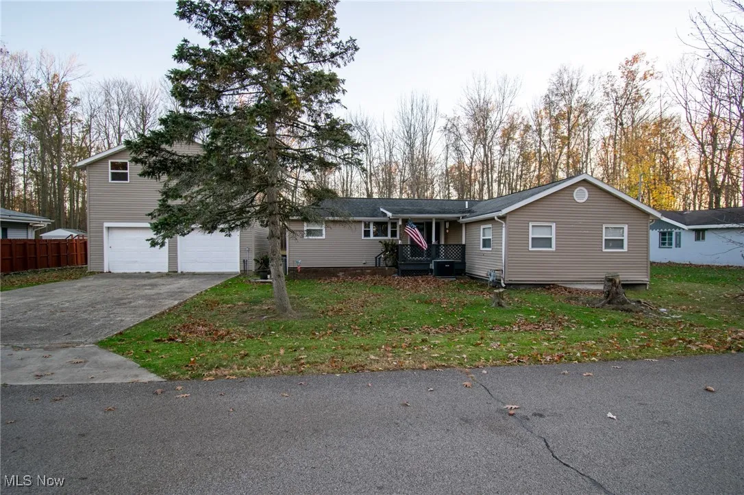 View of front of home with a front yard, fence, and central air condition unit