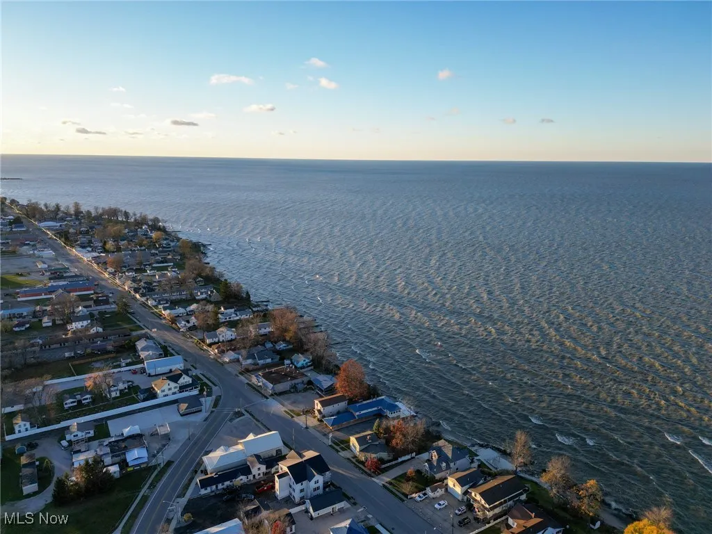 Aerial view at dusk featuring a water view