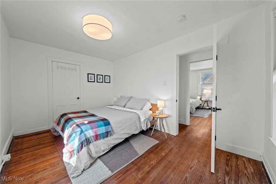Bedroom with baseboards and wood finished floors