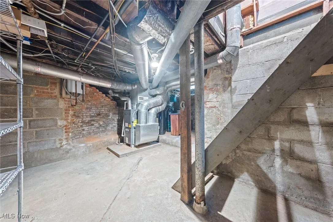 Unfinished below grade area with heating unit