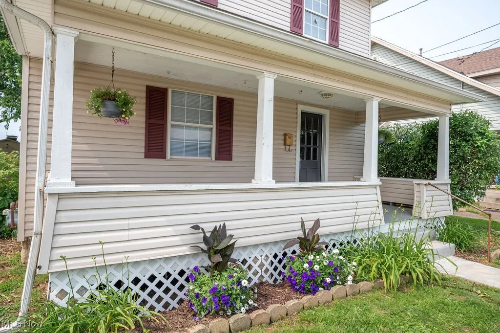 View of exterior entry featuring covered porch