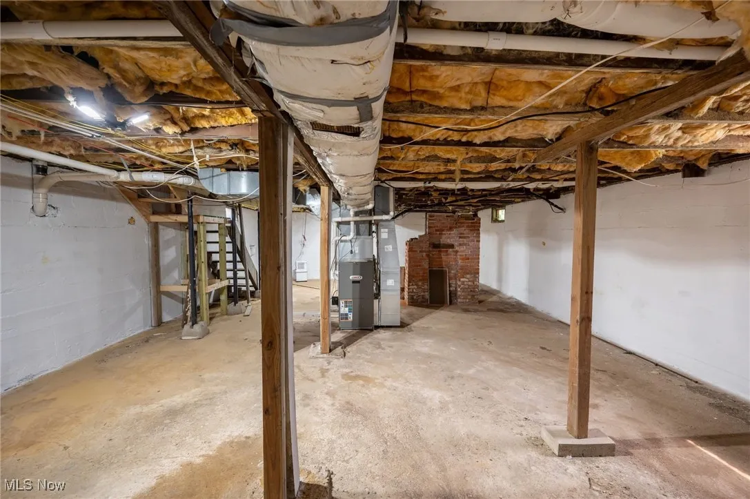 Unfinished below grade area with heating unit