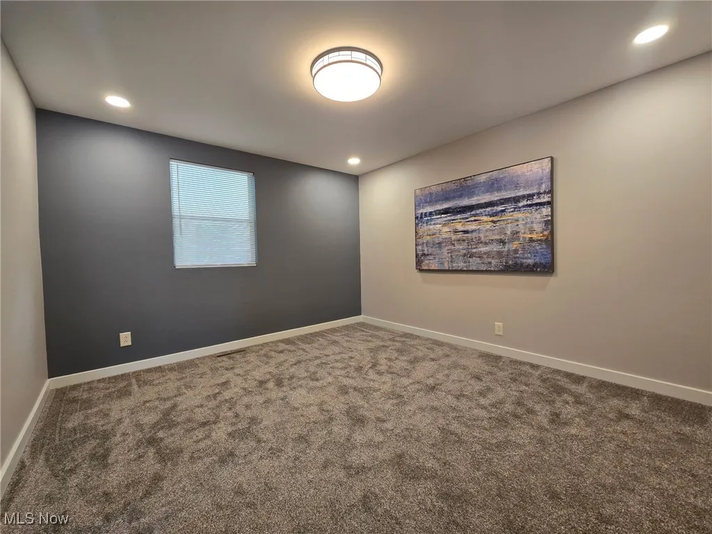 Unfurnished room with carpet, baseboards, and recessed lighting