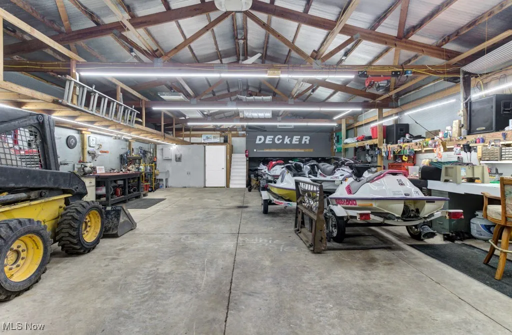 Garage featuring a workshop area and metal walls