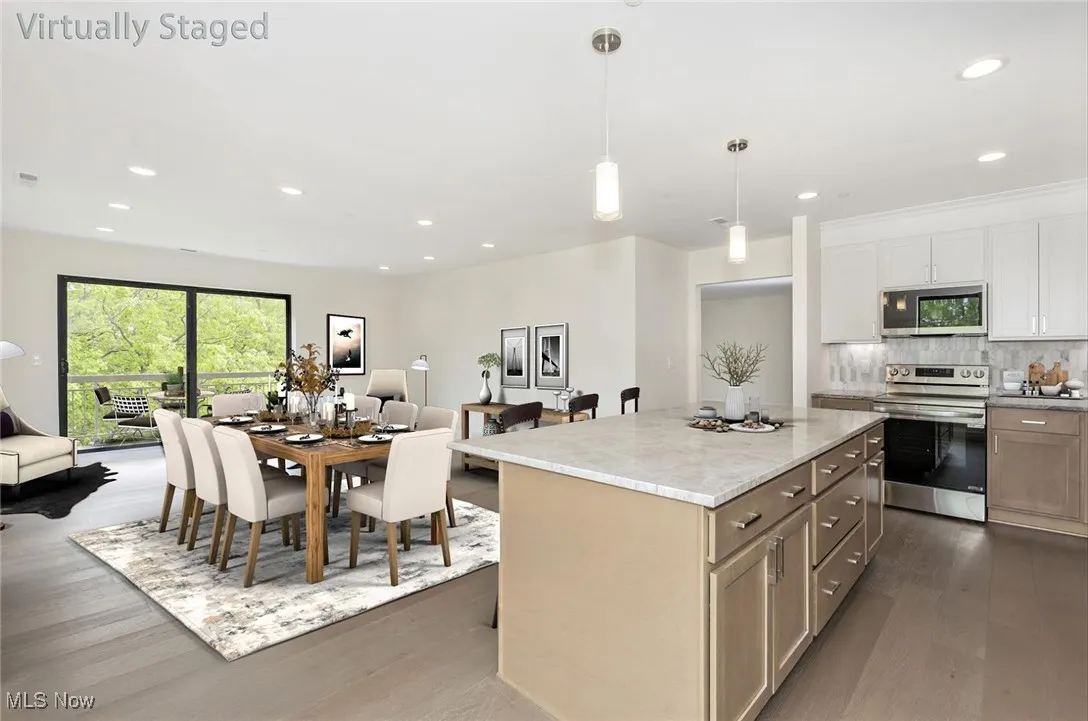 Kitchen featuring appliances with stainless steel finishes, open floor plan, dark wood-style floors, and recessed lighting